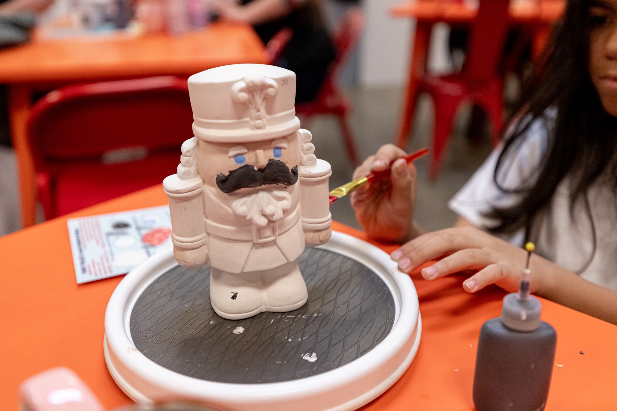 Enthusiastic pottery making at The Hot Spot Franchise, capturing the essence of creativity in the Paint Your Own Pottery Franchise